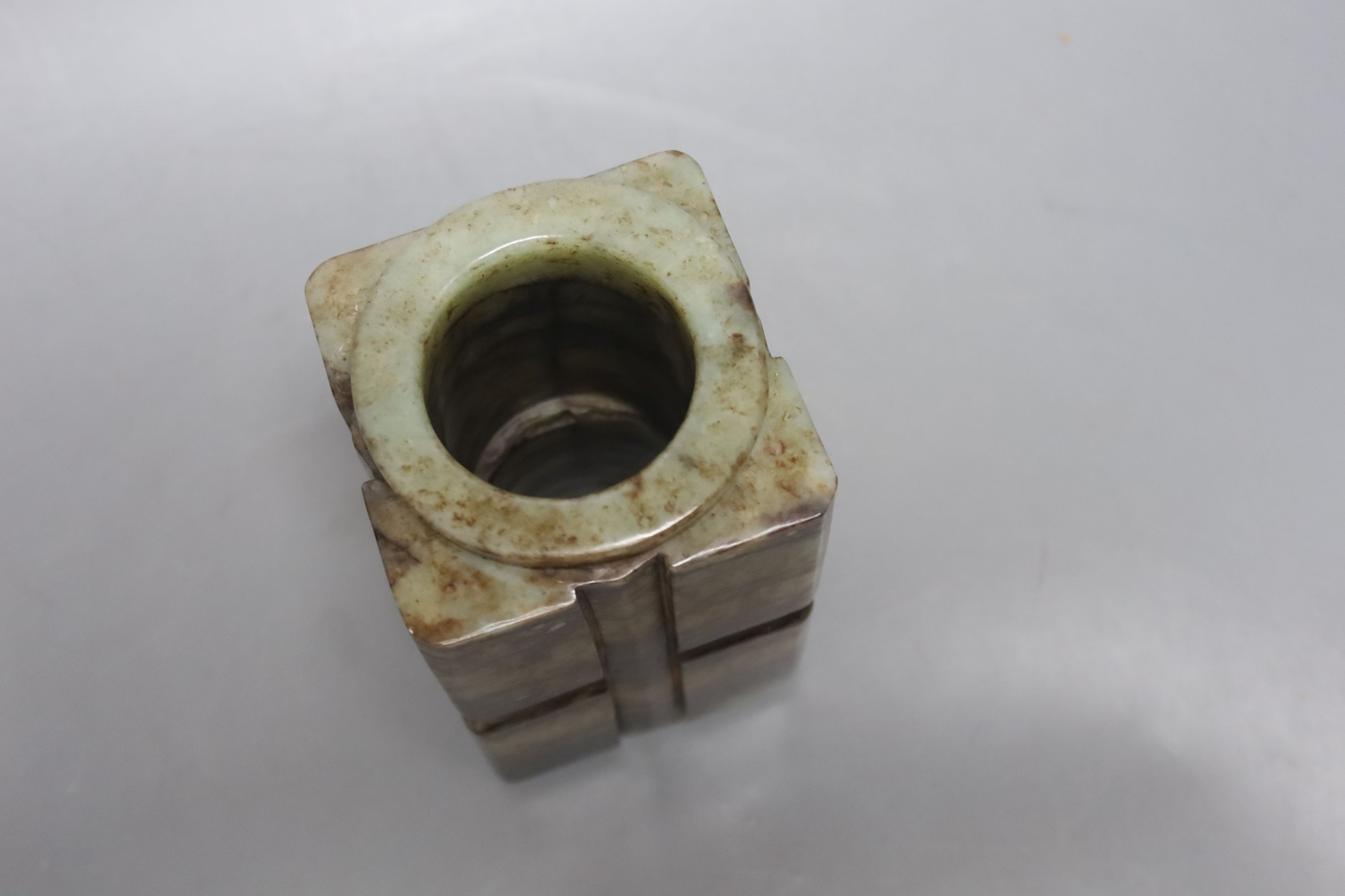 A Chinese pale celadon and black jade cong, H. 14cm